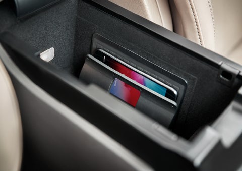 A smartphone device is securely tucked into the available wireless charging pad for an effortless energy boost | Loveland Lincoln in Loveland CO