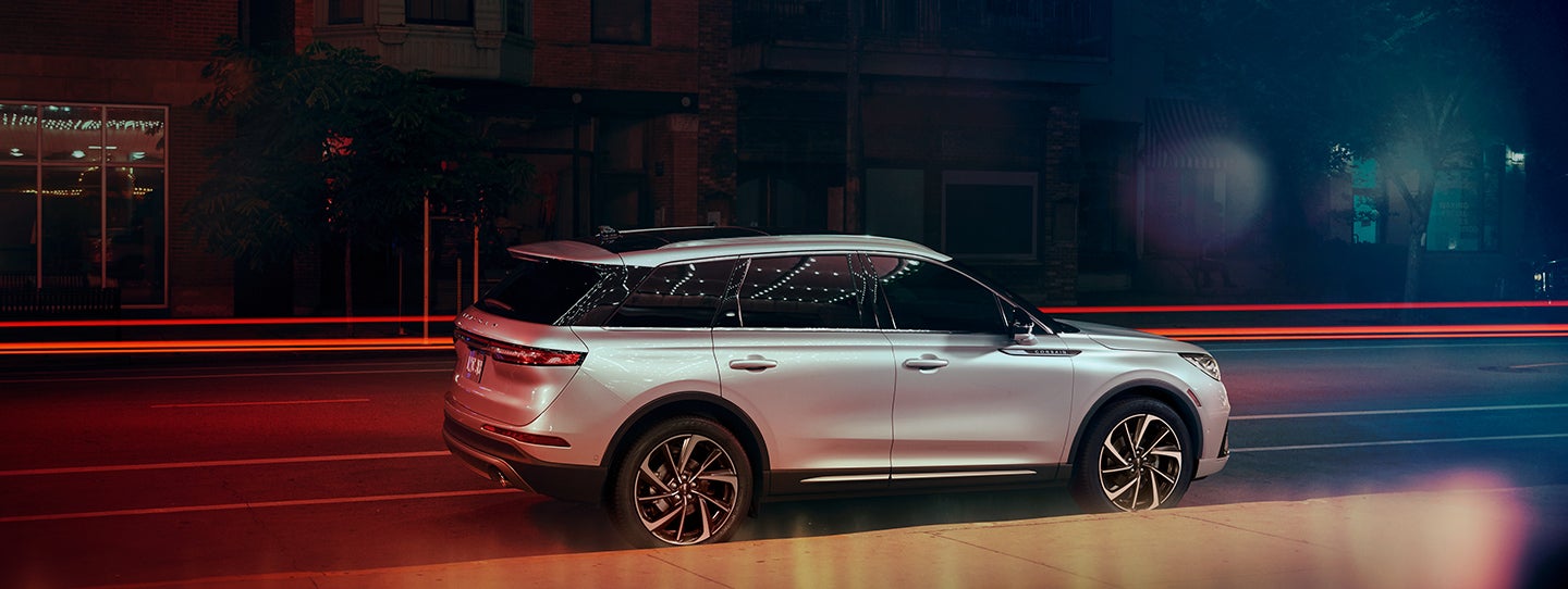 The 2024 Lincoln Corsair® SUV is parked on a city street at night. | Loveland Lincoln in Loveland CO
