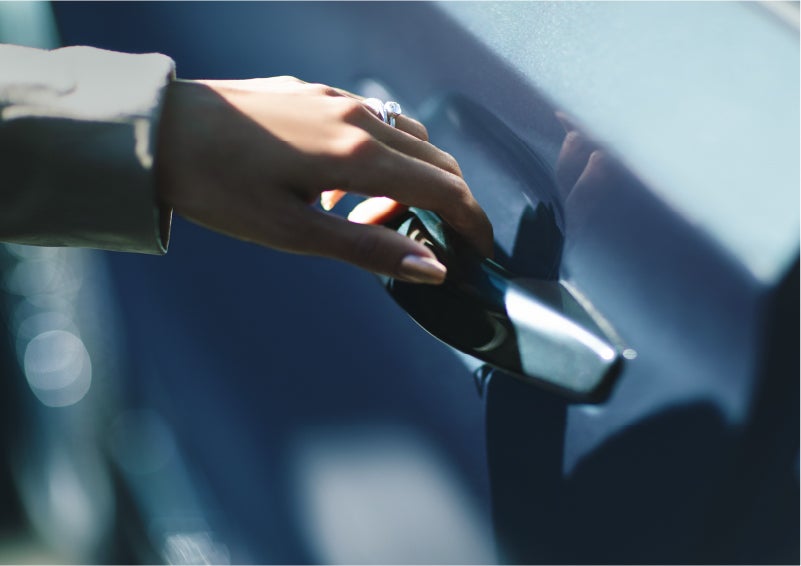 A hand gracefully grips the Light Touch Handle of a 2023 Lincoln Aviator® SUV to demonstrate its ease of use | Loveland Lincoln in Loveland CO