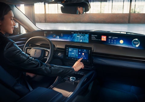 The driver of a 2024 Lincoln Nautilus® SUV interacts with the center touchscreen. | Loveland Lincoln in Loveland CO