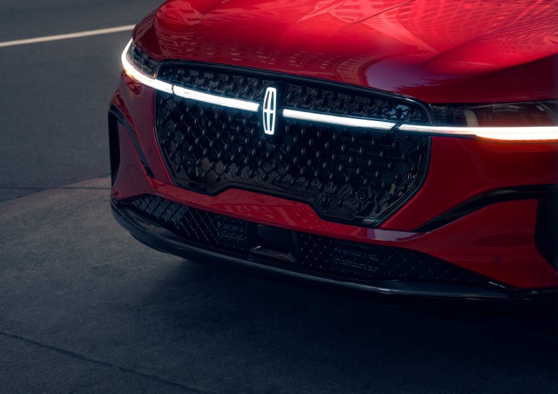 The available front LED light bar and center Lincoln Star logo glow at dusk. | Loveland Lincoln in Loveland CO