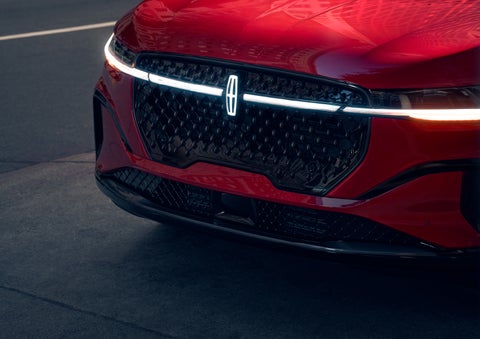 The available front LED light bar and center Lincoln Star logo glow at dusk. | Loveland Lincoln in Loveland CO