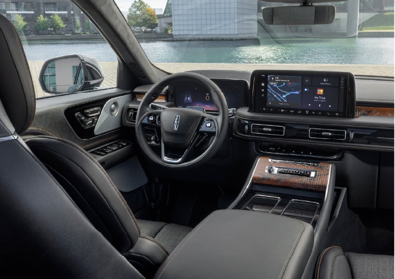 The interior of the 2026 Lincoln Aviator® SUV is shown parked with a view of a harbor through the windshield. | Loveland Lincoln in Loveland CO