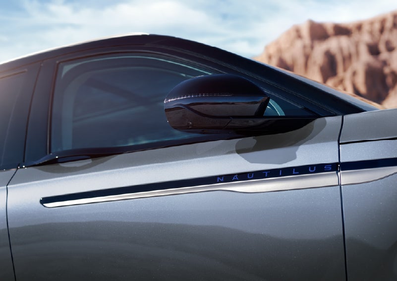 Blue lettering on the side of the vehicle that reads Nautilus indicates the available Hybrid Powertrain. | Loveland Lincoln in Loveland CO