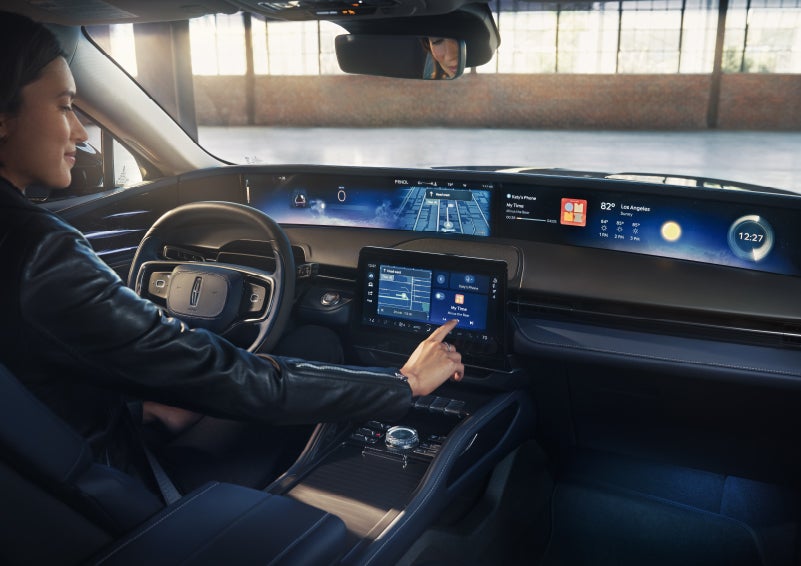 The driver of a 2026 Lincoln Nautilus® SUV interacts with the center touchscreen. | Loveland Lincoln in Loveland CO