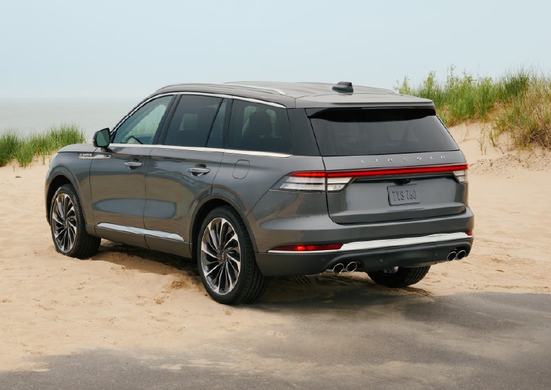A 2027 Lincoln Aviator® SUV is parked next to sand dunes. | Loveland Lincoln in Loveland CO