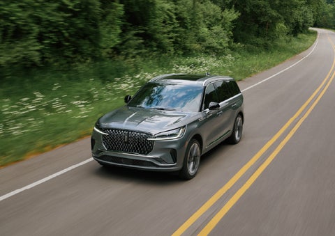 A 2027 Lincoln Aviator® SUV is being driven down a road. | Loveland Lincoln in Loveland CO