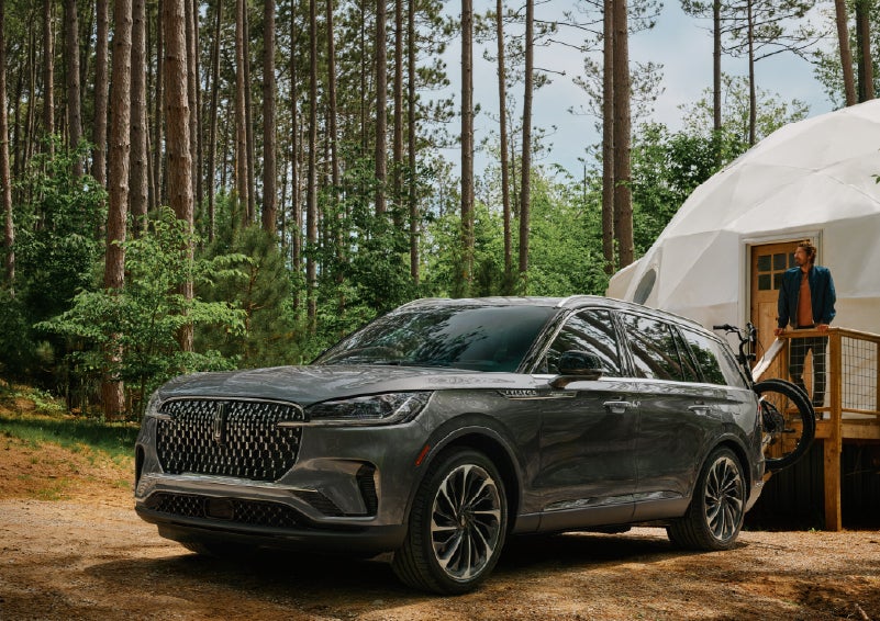 A 2027 Lincoln Aviator® is parked next to a high end glamping site. | Loveland Lincoln in Loveland CO