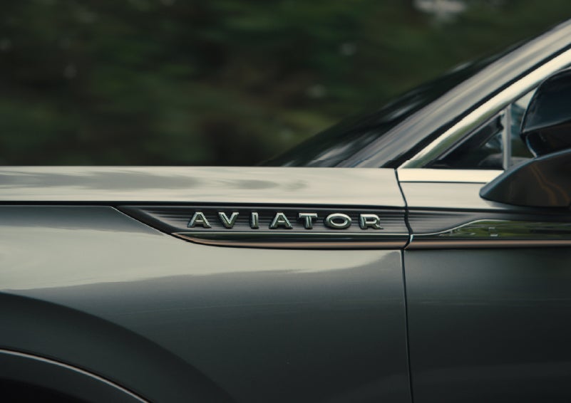 The driver’s side door and fender badging of a gray 2027 Lincoln Aviator® SUV are showcased. | Loveland Lincoln in Loveland CO