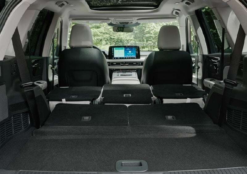 A rear to front view of the interior of a 2027 Lincoln Aviator® Black Label™ SUV shows the third and second rows folded flat | Loveland Lincoln in Loveland CO