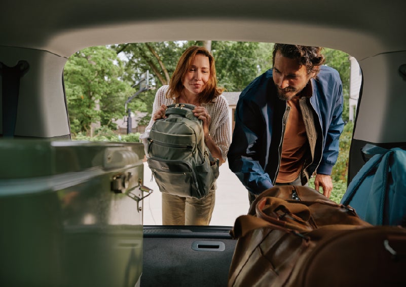 A couple loads luggage into the rear of a 2027 Lincoln Aviator® Black Label™ SUV..e 202 | Loveland Lincoln in Loveland CO